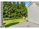 Lush backyard with a concrete patio area and mature trees providing privacy and shade at 127 Cedar Elm Rd, Durham, NC 27713