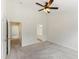 Spacious bedroom featuring neutral carpet, ceiling fan, and access to the bathroom and hallway at 127 Cedar Elm Rd, Durham, NC 27713