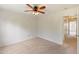 Bedroom with neutral carpet, ceiling fan, and a door leading to the hallway at 127 Cedar Elm Rd, Durham, NC 27713