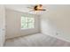 Bedroom with neutral carpet, ceiling fan, and a window providing plenty of natural light at 127 Cedar Elm Rd, Durham, NC 27713