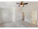 Comfortable bedroom featuring neutral carpet, ceiling fan, and closet with double doors at 127 Cedar Elm Rd, Durham, NC 27713