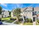 Inviting townhome exterior boasting well-maintained lawn and attractive architectural details on a sunny day at 127 Cedar Elm Rd, Durham, NC 27713