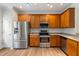 Modern kitchen featuring stainless steel appliances, sleek countertops, and wooden cabinetry for efficient cooking at 127 Cedar Elm Rd, Durham, NC 27713