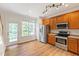 Well-lit kitchen with stainless steel appliances, wooden cabinets, and a view to the backyard at 127 Cedar Elm Rd, Durham, NC 27713