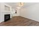 Bright living room featuring a fireplace and modern flooring with a view into the kitchen at 127 Cedar Elm Rd, Durham, NC 27713
