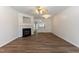 Cozy living room boasts a fireplace and is open to the kitchen creating an inviting and connected space at 127 Cedar Elm Rd, Durham, NC 27713