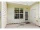 A cozy patio with a back door and a large window offering natural light, perfect for outdoor relaxation and entertainment at 127 Cedar Elm Rd, Durham, NC 27713