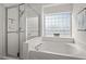 Modern bathroom featuring a glass-enclosed shower and separate soaking tub at 1308 Snyder St, Durham, NC 27713