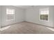 Bedroom with neutral tones and natural light from two windows at 1308 Snyder St, Durham, NC 27713