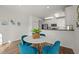 Eat-in kitchen features a white table with blue chairs and stainless steel appliances at 1308 Snyder St, Durham, NC 27713