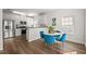 Eat-in kitchen area showcases a modern table with stylish blue chairs and stainless steel appliances at 1308 Snyder St, Durham, NC 27713