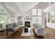 Inviting living room features a fireplace, built-in shelving, and large windows for plenty of natural light at 1308 Snyder St, Durham, NC 27713