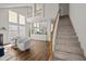 Bright living room with vaulted ceilings, hardwood floors, and stairs leading up to the second floor at 1308 Snyder St, Durham, NC 27713