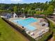 Aerial view of a community pool featuring lounge chairs and a spacious pool area with mature trees in the background at 1308 Snyder St, Durham, NC 27713
