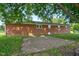 Exterior shot of a red brick home featuring a brick patio and grass at 1308 Tyson Loop Rd, Spring Hope, NC 27882