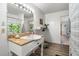 Comfortable bathroom with granite countertop, wood-look flooring, and a large mirror, creating a relaxing space at 1308 Tyson Loop Rd, Spring Hope, NC 27882