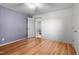 Cozy bedroom featuring wood-look floors, neutral walls, and a doorway, creating a private retreat at 1308 Tyson Loop Rd, Spring Hope, NC 27882