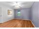 Comfortable bedroom with wood-look flooring, ample natural light from a window, and soft wall colors at 1308 Tyson Loop Rd, Spring Hope, NC 27882