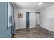 Serene bedroom with wood-look floors, a closet, and a window, creating a calming and restful atmosphere at 1308 Tyson Loop Rd, Spring Hope, NC 27882