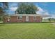 Inviting brick ranch featuring a well-manicured lawn and ample parking at 1308 Tyson Loop Rd, Spring Hope, NC 27882