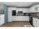 Updated kitchen with white cabinets, sleek countertops, and patterned backsplash, offering a blend of style and functionality at 1308 Tyson Loop Rd, Spring Hope, NC 27882