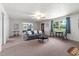 Spacious living room with seating and large windows at 1308 Tyson Loop Rd, Spring Hope, NC 27882