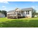 Spacious backyard featuring a wooden deck, screened in porch, and well-kept lawn at 139 His Way, Middlesex, NC 27557
