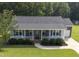 This angle showcases the charming single-Gathering home with manicured landscaping and a cozy front porch at 139 His Way, Middlesex, NC 27557
