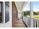Inviting covered front porch featuring classic wood flooring and elegant railing at 139 His Way, Middlesex, NC 27557