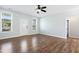Bright living room with stylish wood flooring, neutral walls, and a ceiling fan at 139 His Way, Middlesex, NC 27557