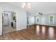 Open-concept living room with hardwood floors and view of the kitchen, dining and front entrance at 139 His Way, Middlesex, NC 27557