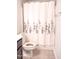 Bathroom featuring a shower with a flower patterned curtain and a toilet at 1402 Southpoint Trl, Durham, NC 27713