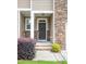 Inviting front entrance with a covered porch and stone accents, creating a welcoming approach at 1402 Southpoint Trl, Durham, NC 27713