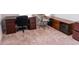Carpeted home office with desk, shelves, and comfortable swivel chair at 1402 Southpoint Trl, Durham, NC 27713