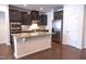 Modern kitchen boasts stainless appliances, a large island with granite countertops, and dark cabinets at 1402 Southpoint Trl, Durham, NC 27713