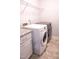 Bright laundry room with granite countertop and modern, front-load washer and dryer at 1402 Southpoint Trl, Durham, NC 27713