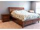 Large main bedroom featuring a wooden bedframe, carpet flooring, and natural light at 1402 Southpoint Trl, Durham, NC 27713