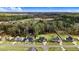 An aerial view of a beautiful community with well-maintained homes and landscaping, surrounded by trees at 147 Everwood Dr, Four Oaks, NC 27524