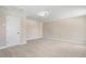 Neutral bedroom features plush carpeting, neutral walls, and a ceiling light fixture at 147 Everwood Dr, Four Oaks, NC 27524