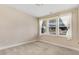 Bedroom featuring neutral walls, carpeted floors, and a window with neighborhood views at 147 Everwood Dr, Four Oaks, NC 27524