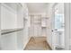Spacious walk-in closet features built-in shelving and drawers, with access to the bathroom at 147 Everwood Dr, Four Oaks, NC 27524