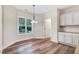 Bright dining area with lots of natural light, featuring a chandelier and white cabinets and backsplash at 147 Everwood Dr, Four Oaks, NC 27524