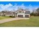 Lovely home showcasing a spacious yard, three-car garage, and attractive architectural details at 147 Everwood Dr, Four Oaks, NC 27524