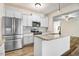 Spacious kitchen with stainless steel refrigerator, granite countertops, white cabinets, and modern appliances at 147 Everwood Dr, Four Oaks, NC 27524