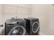 Laundry room featuring a front loading washer and dryer and wire shelving at 147 Everwood Dr, Four Oaks, NC 27524