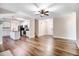 Open-concept living area featuring hardwood floors, natural light, and seamless transition to the kitchen at 147 Everwood Dr, Four Oaks, NC 27524