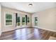 Sunlit living area with hardwood floors and access to an outdoor deck at 147 Everwood Dr, Four Oaks, NC 27524