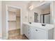 Main bathroom with dual sinks, large mirror, and separate toilet and shower rooms, plus a large closet at 147 Everwood Dr, Four Oaks, NC 27524