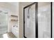 Modern main bathroom featuring a glass enclosed shower and a soaking tub with a tub filler at 147 Everwood Dr, Four Oaks, NC 27524