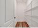 Walk-in pantry with wire shelving for optimized storage, next to a white door with dark knob at 147 Everwood Dr, Four Oaks, NC 27524
